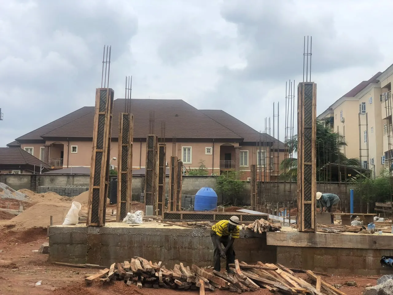 Reinforced columns in timber formwork rising from a raised foundation